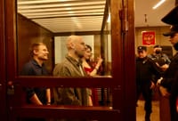 Left to right: journalists Konstantin Gabov, Sergey Karelin, and Antonina Favorskaya during sentencing on April 15. Artyom Kriger is seen behind them.