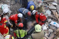 Emergency workers preparing to transport a body pulled out from under the rubble of a building in Kyiv, Ukraine, on April 24.