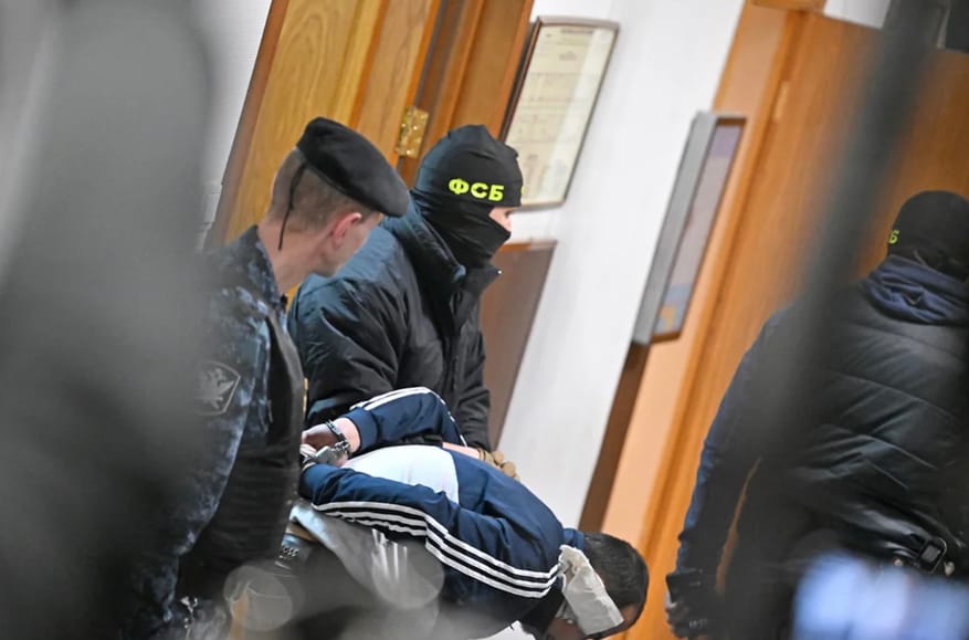 Four men with signs of severe beating charged with terrorism by Moscow court in Crocus City Hall case