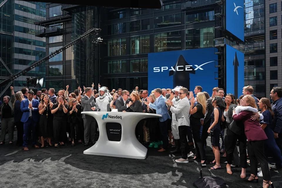 SpaceX leadership members and guests celebrate on a balcony at the Nasdaq MarketSite on the day of SpaceX's initial public offering (IPO), in New York City, U.S., June 12, 2026. REUTERS/Brendan McDermid/File Photo Purchase Licensing Rights