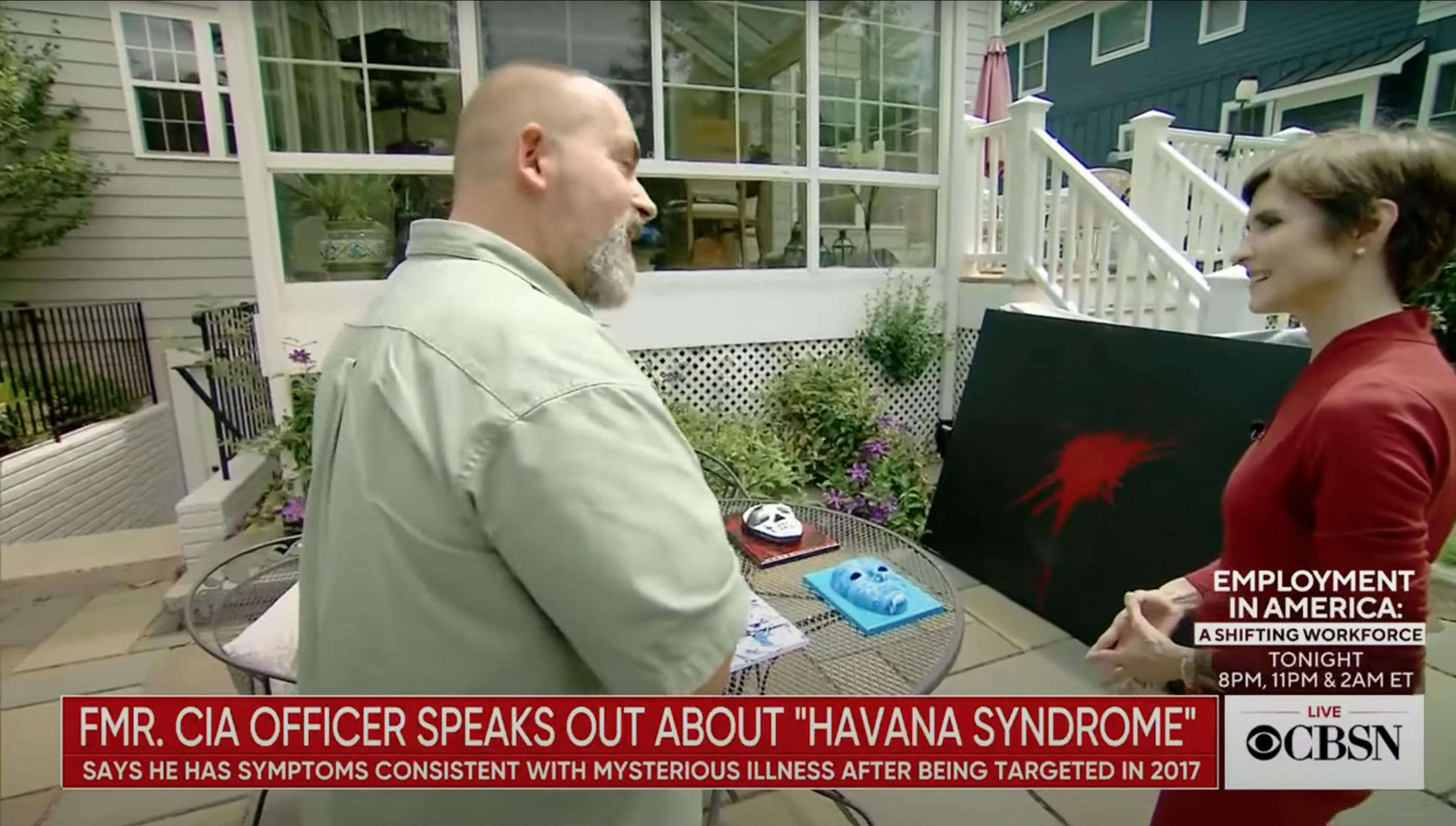 Marc Polymeropoulos showing “The Gunshot” during an interview with CBS News in 2021